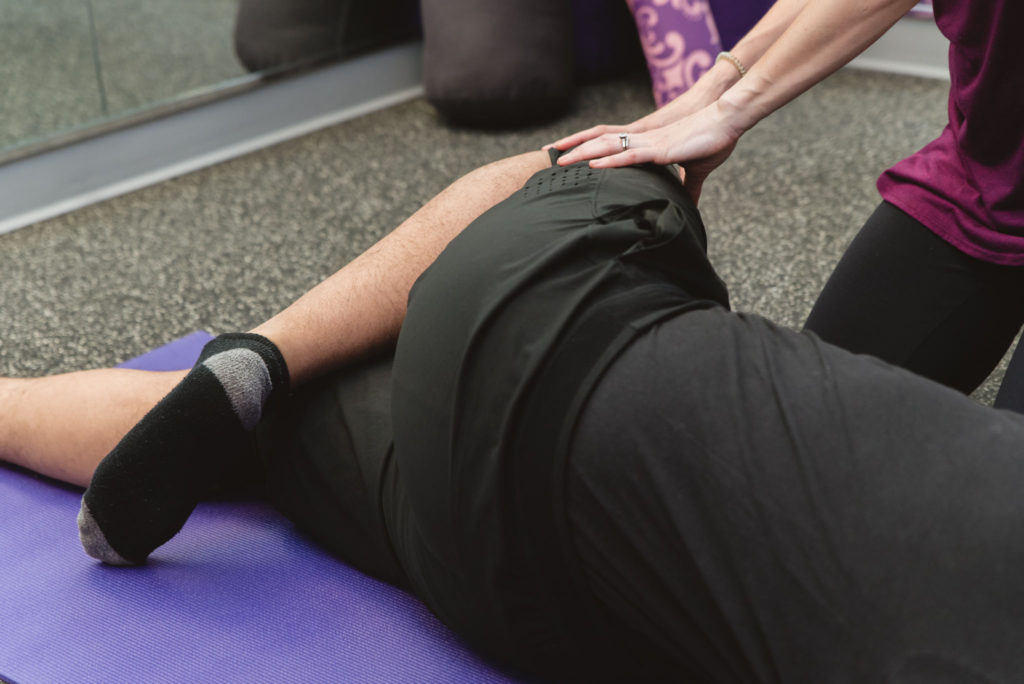 Bowel Dysfunction contact image. Photo of a woman stretching in a physical therapy session for Bowel Dysfunction.